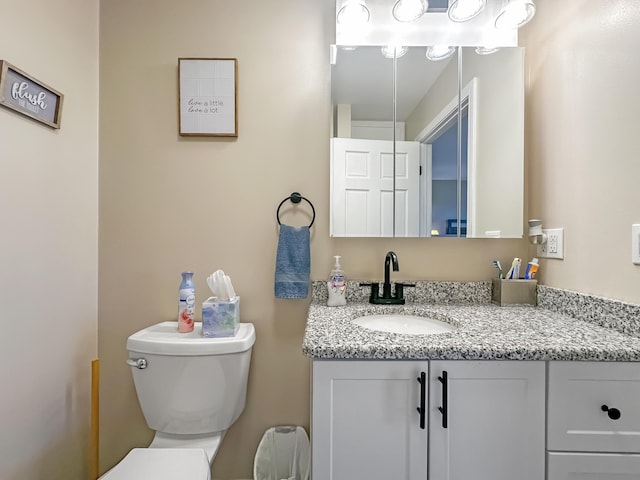 bathroom with toilet and vanity