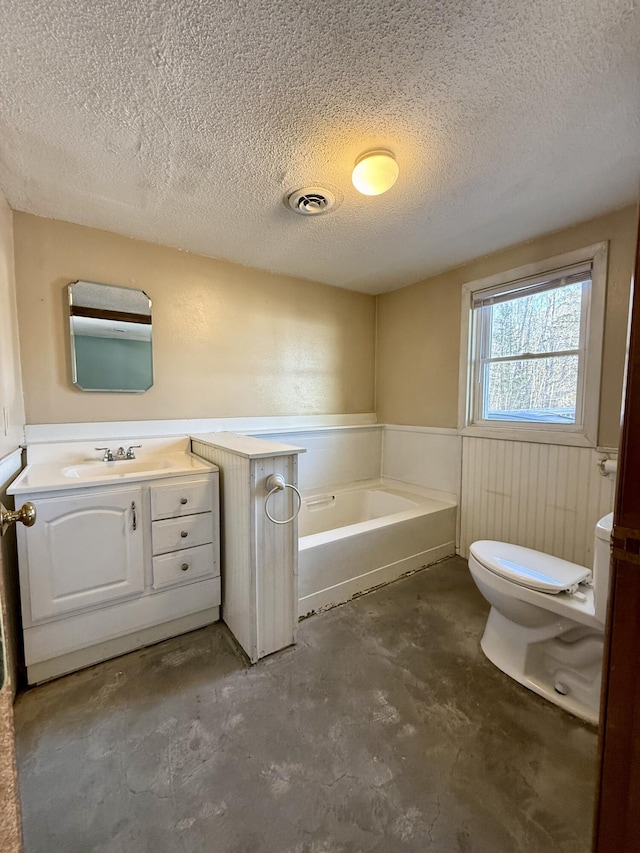 bathroom featuring a textured ceiling, a garden tub, a wainscoted wall, concrete floors, and visible vents