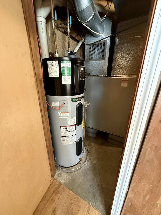 utility room featuring water heater and visible vents