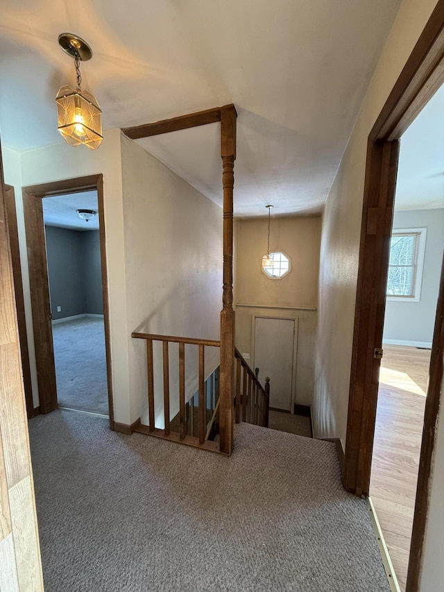 staircase featuring carpet flooring and baseboards