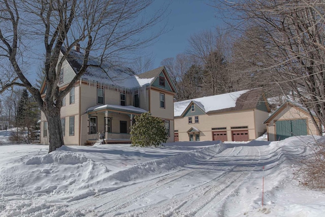 victorian house featuring a garage and covered porch