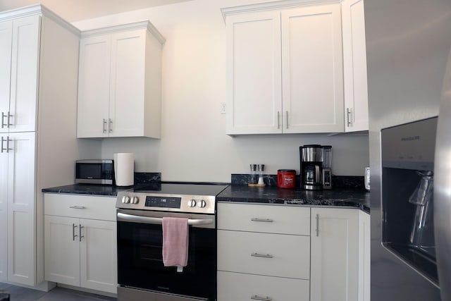 kitchen featuring stainless steel appliances and white cabinetry