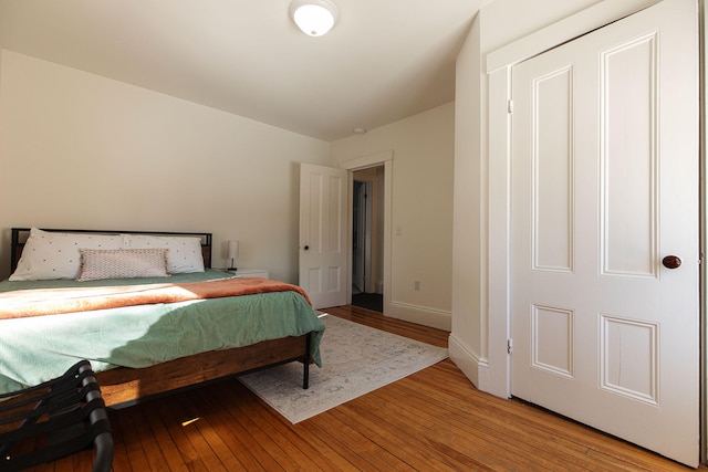 bedroom featuring light wood-style flooring and baseboards