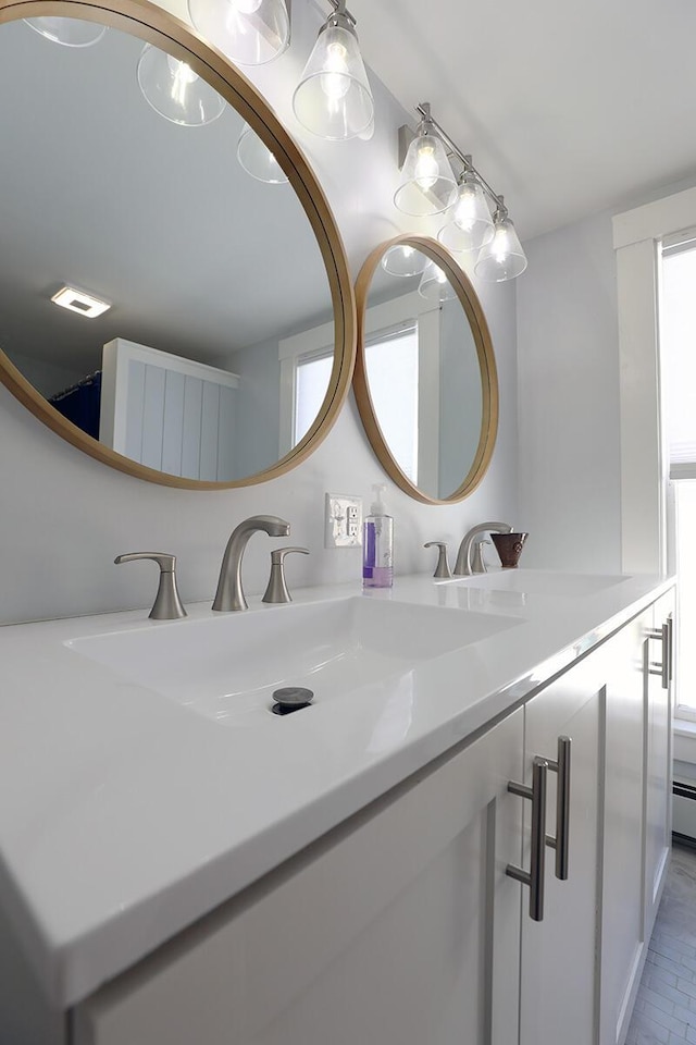 bathroom with a baseboard radiator and vanity