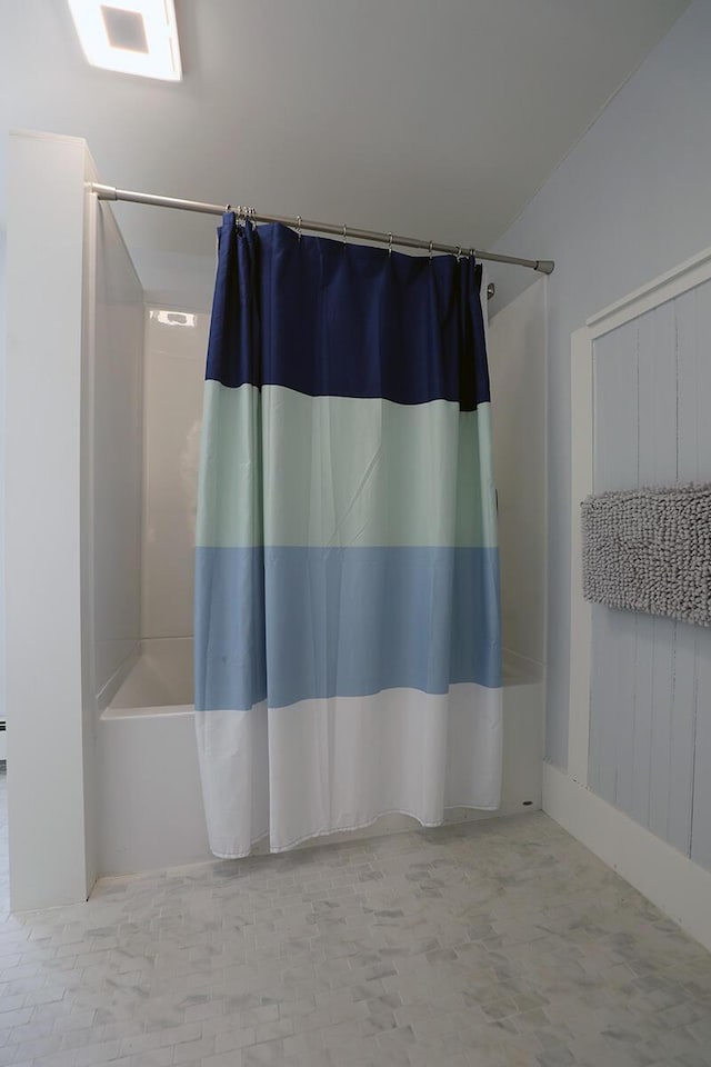 full bathroom with shower / bath combo with shower curtain