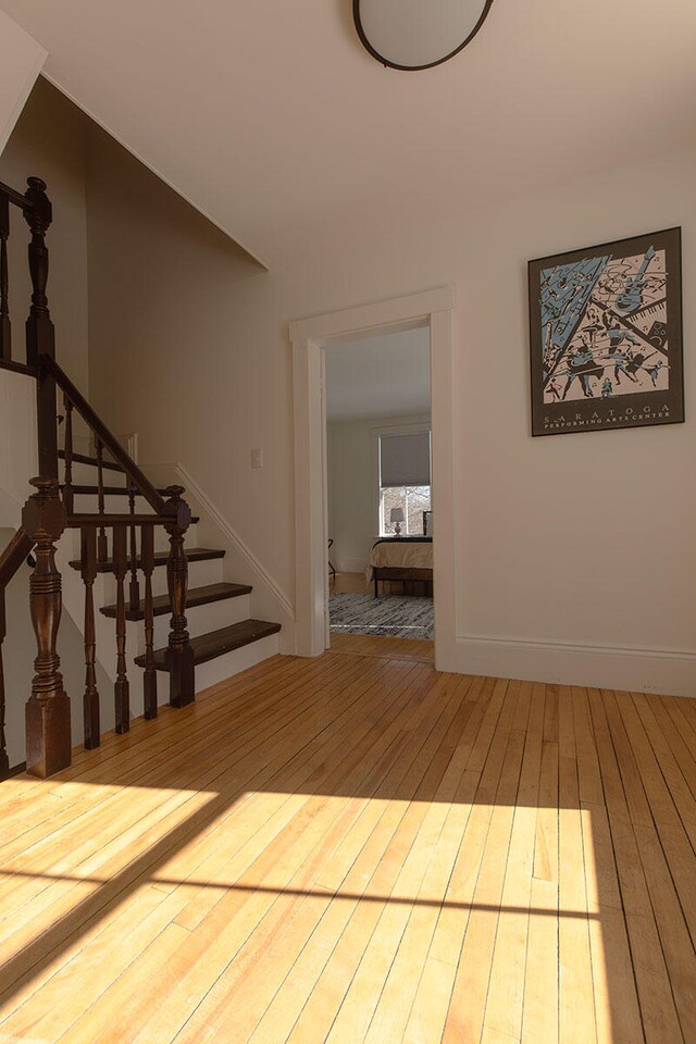 interior space featuring stairs, baseboards, and wood finished floors