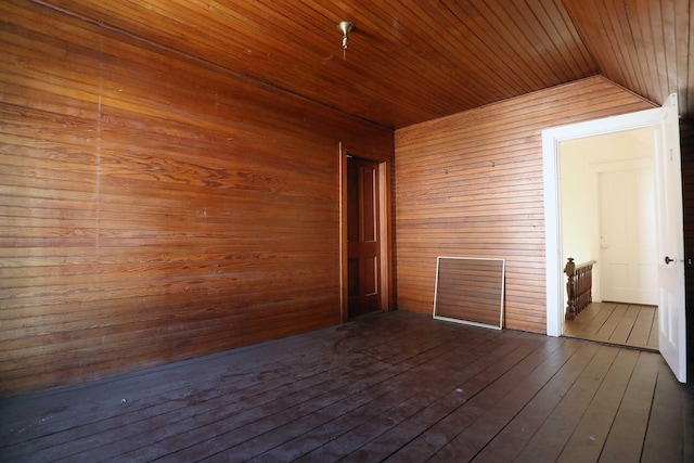 unfurnished room with dark wood-style floors and wooden ceiling