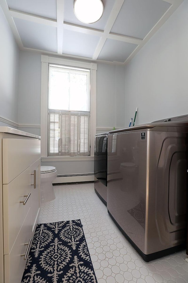 laundry area featuring a baseboard radiator and light floors