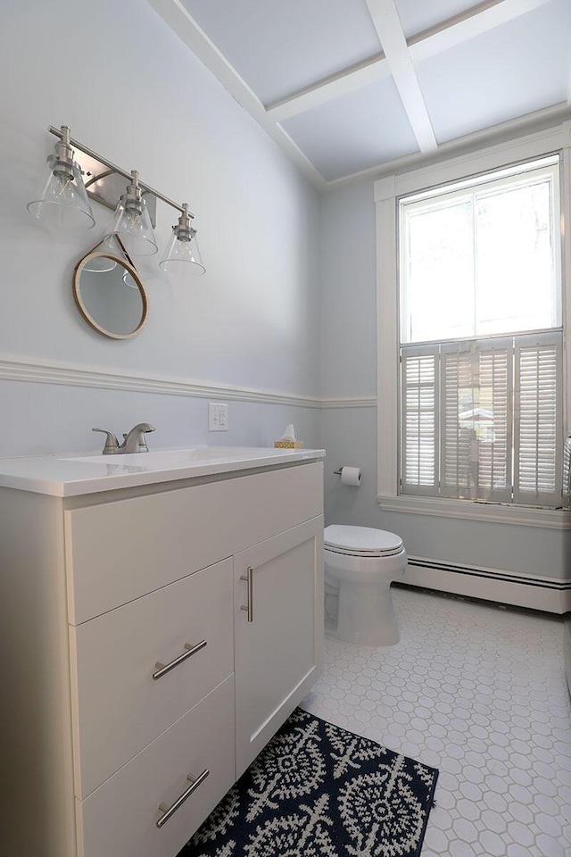 bathroom featuring toilet, baseboard heating, and vanity