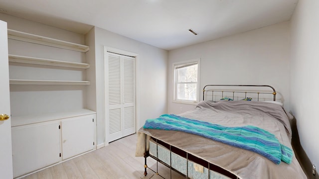 bedroom featuring light wood-style floors and a closet