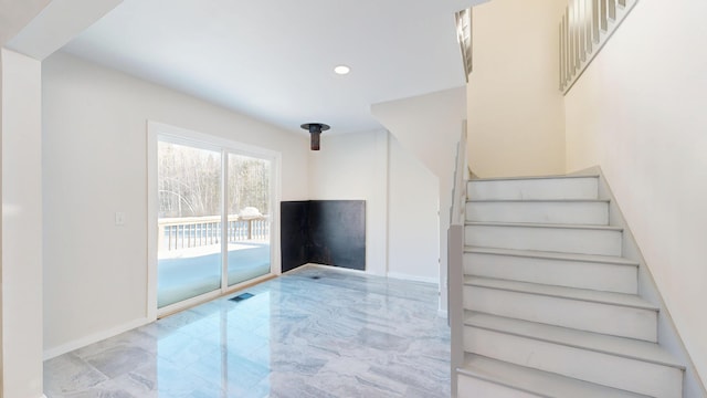 stairs with marble finish floor, recessed lighting, and baseboards