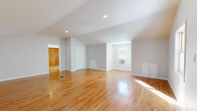 additional living space featuring recessed lighting, baseboards, vaulted ceiling, and light wood finished floors