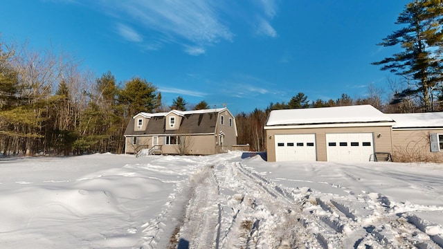 view of front of property featuring a garage and a gambrel roof