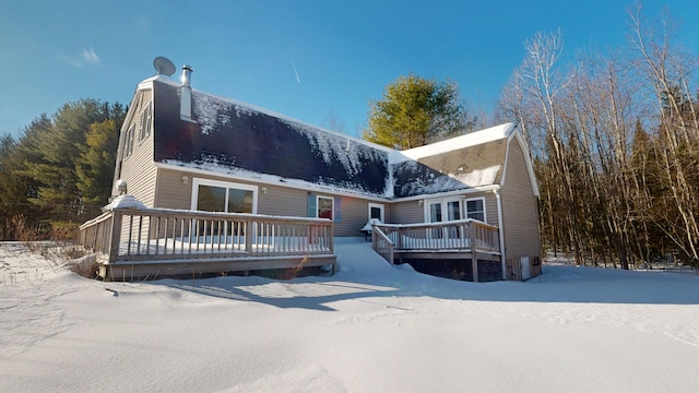 view of front of home with a deck and a gambrel roof