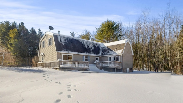 view of front of house featuring a deck and a gambrel roof