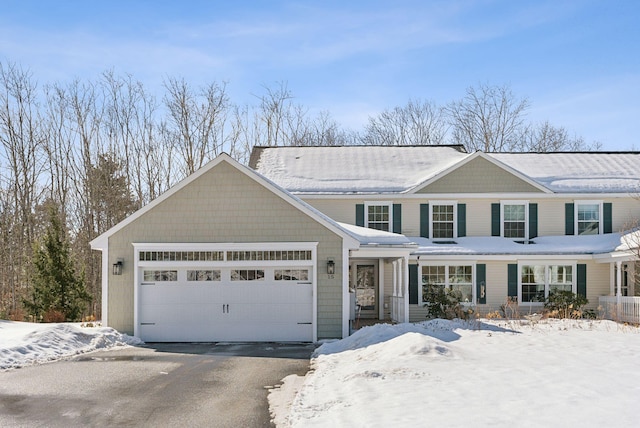 view of front of property with aphalt driveway and an attached garage