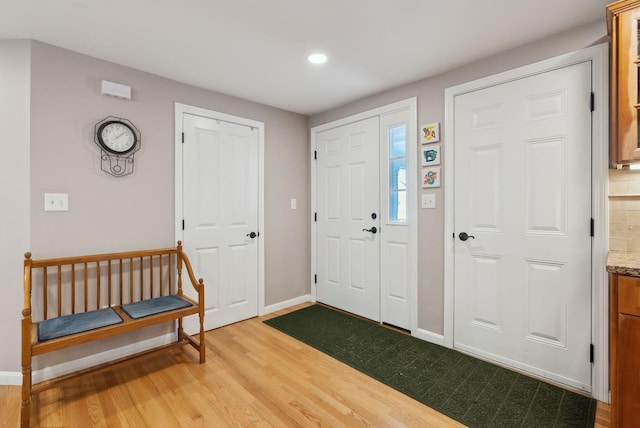 entryway featuring light wood-style floors, recessed lighting, and baseboards