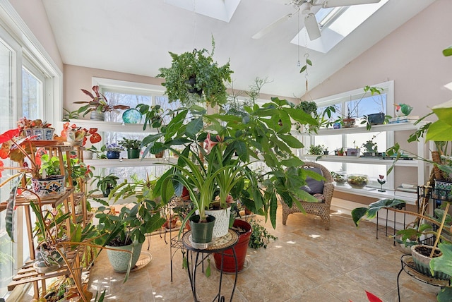 interior space featuring lofted ceiling with skylight and ceiling fan