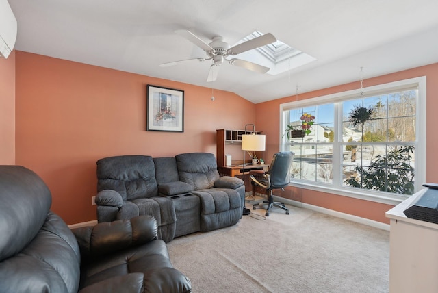 carpeted living area featuring ceiling fan, lofted ceiling with skylight, and baseboards