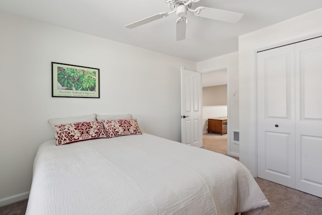 carpeted bedroom featuring ceiling fan and a closet