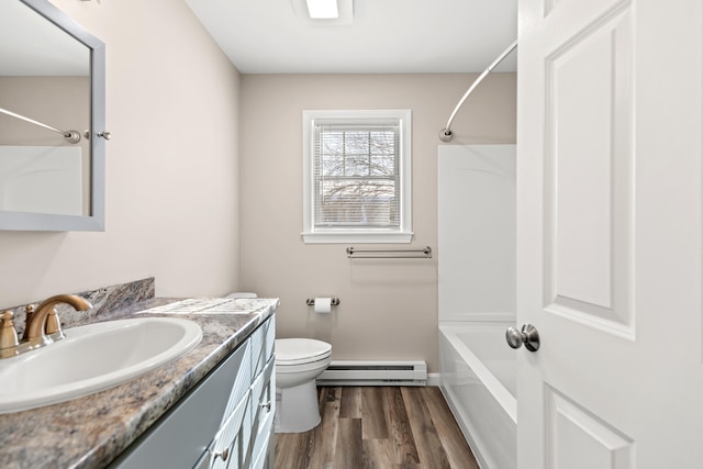 full bathroom with shower / bathtub combination, a baseboard radiator, toilet, vanity, and wood finished floors