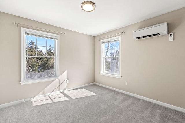 unfurnished room featuring light carpet, a wall mounted air conditioner, and baseboards