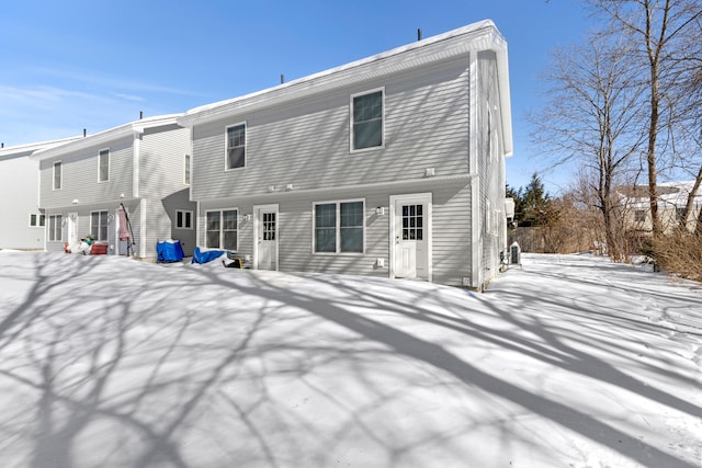 view of snow covered back of property