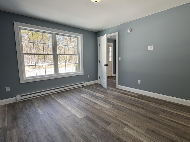 unfurnished room featuring a baseboard radiator, dark wood finished floors, and baseboards