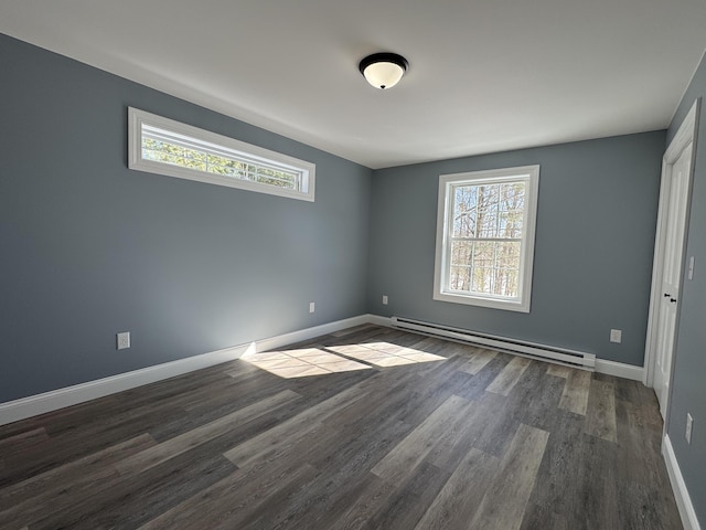 unfurnished bedroom with a baseboard heating unit, dark wood-style flooring, multiple windows, and baseboards