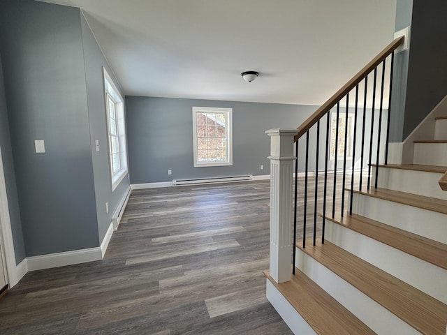 foyer featuring a baseboard radiator, stairs, baseboards, and dark wood finished floors