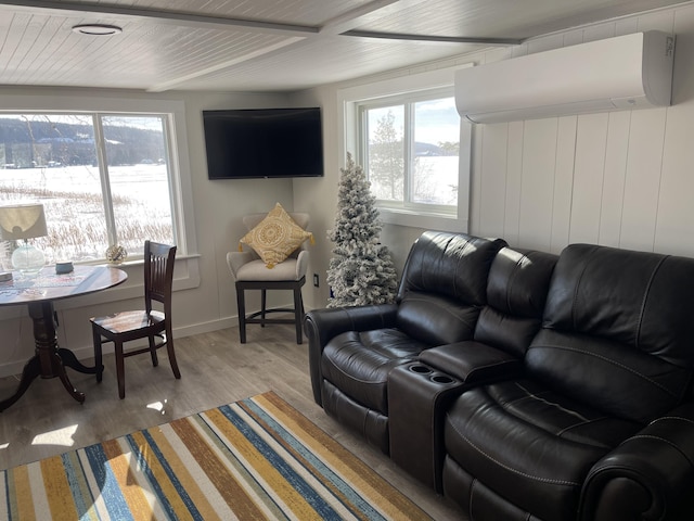 living area with baseboards, a wall mounted AC, wooden ceiling, and light wood-style floors