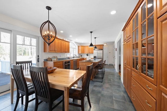 dining area featuring a chandelier, recessed lighting, and dark tile patterned floors