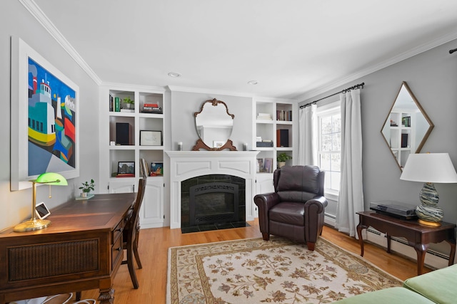 living area with a tiled fireplace, baseboard heating, crown molding, light wood-type flooring, and built in shelves