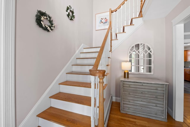 stairs featuring baseboards and wood finished floors