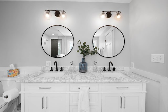 full bath featuring double vanity and a sink