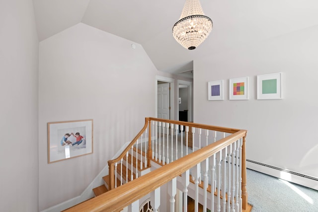 hall with carpet floors, a notable chandelier, lofted ceiling, a baseboard heating unit, and an upstairs landing