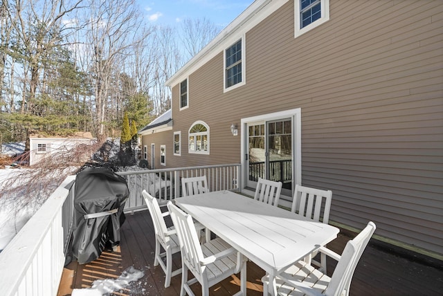 wooden deck featuring outdoor dining space and area for grilling