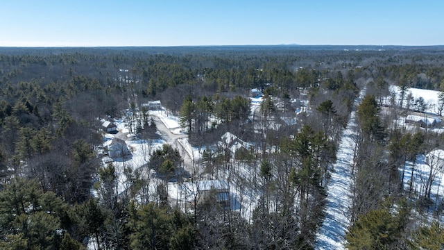 drone / aerial view featuring a wooded view