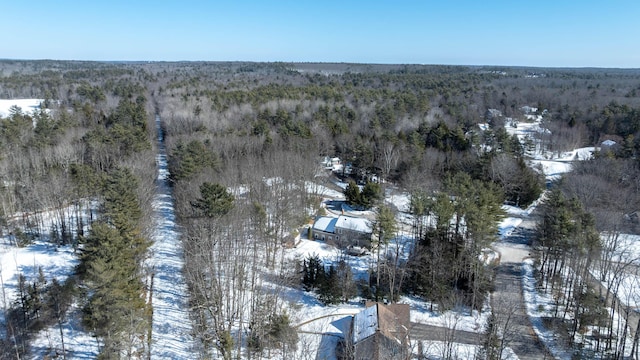 snowy aerial view with a wooded view