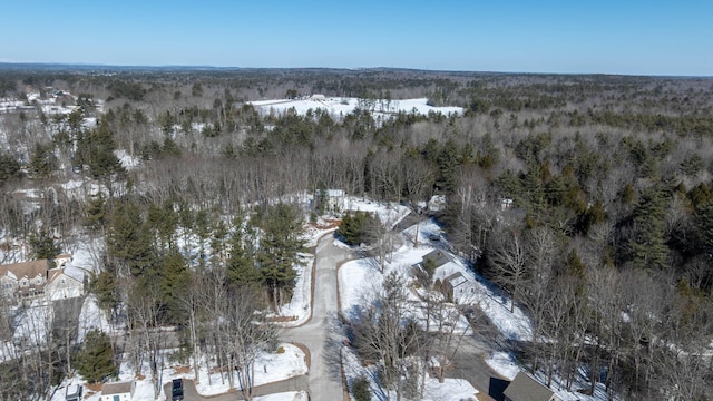 snowy aerial view featuring a view of trees