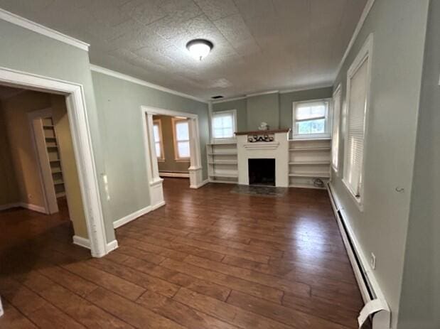 unfurnished living room with a fireplace, baseboards, ornamental molding, baseboard heating, and dark wood-style floors