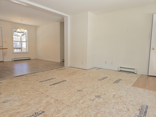 unfurnished room featuring a baseboard heating unit, baseboard heating, baseboards, and a notable chandelier