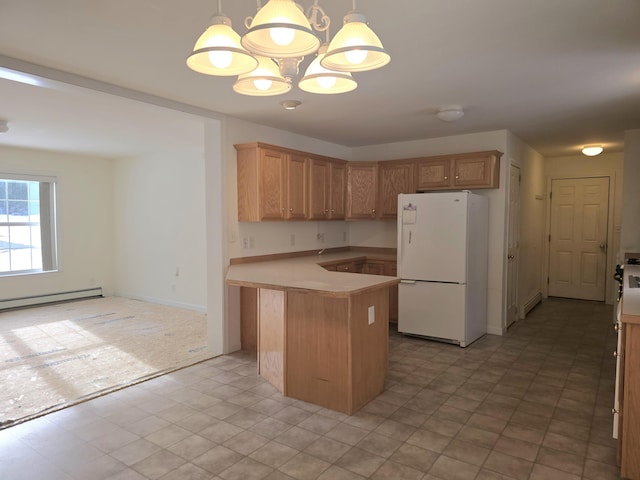 kitchen with decorative light fixtures, a notable chandelier, light countertops, baseboard heating, and freestanding refrigerator