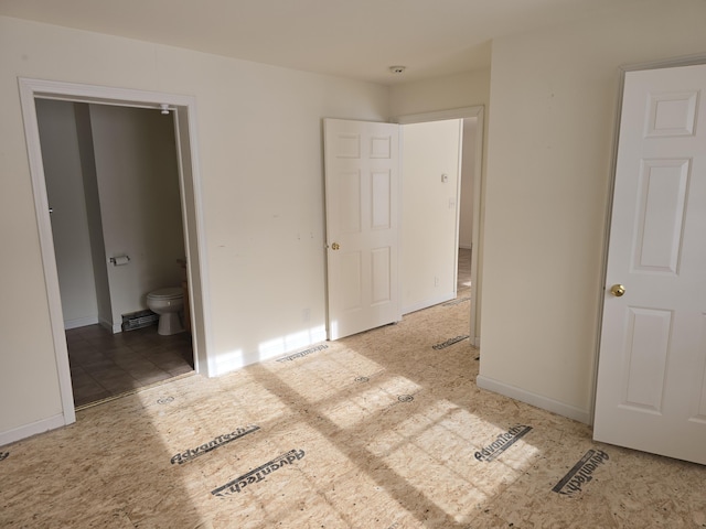 unfurnished bedroom featuring ensuite bathroom, visible vents, and baseboards