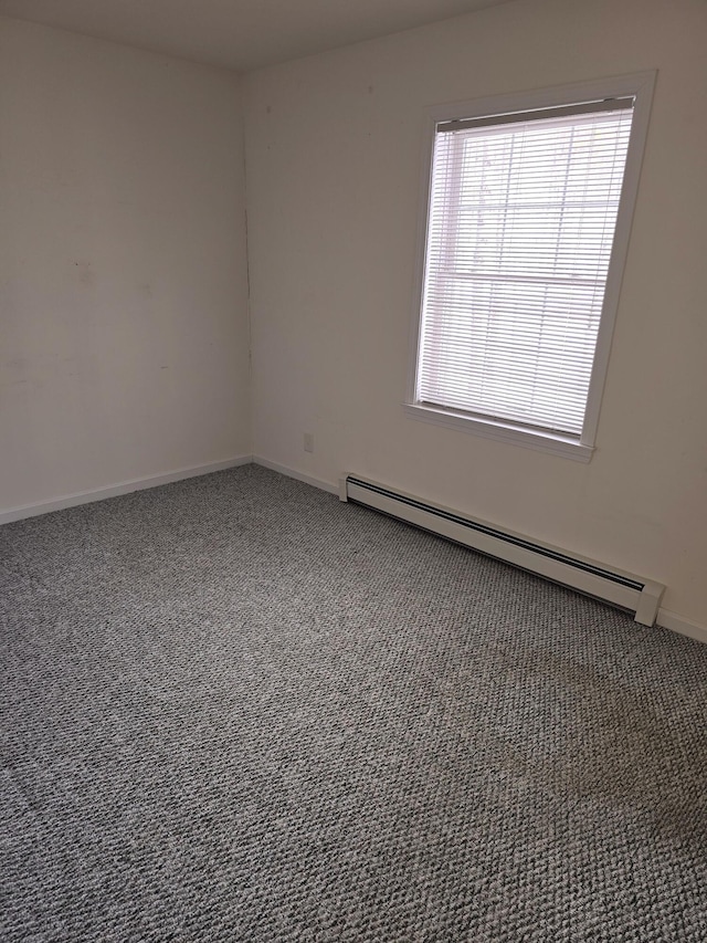 carpeted spare room featuring baseboards and baseboard heating