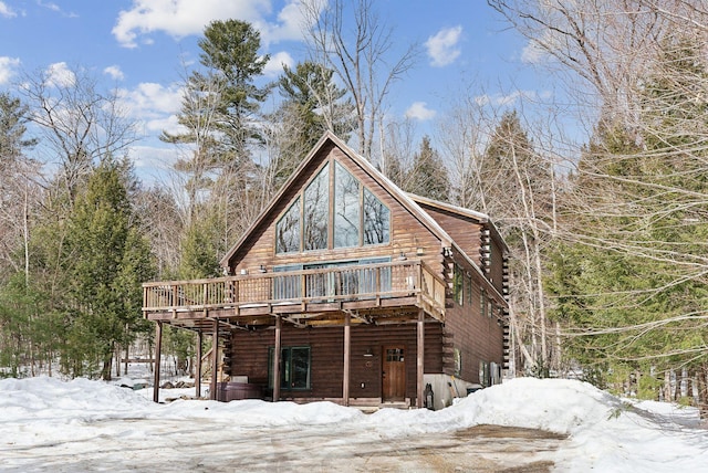 view of front of property with a deck and log siding