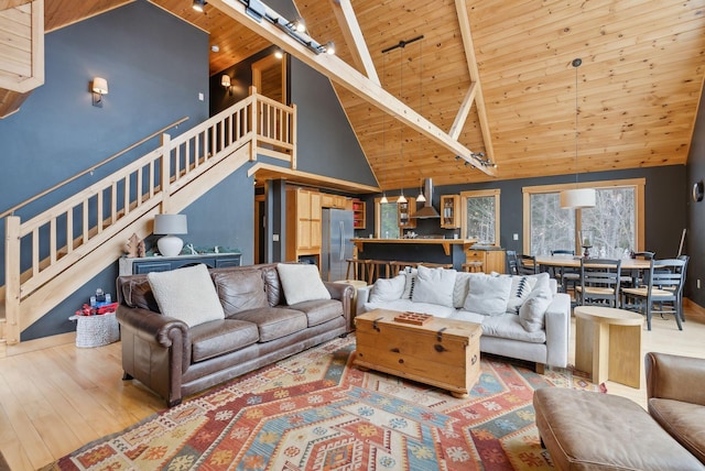 living area with wooden ceiling, stairs, track lighting, and wood finished floors