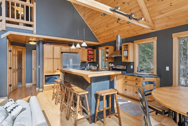 kitchen with wooden ceiling, wall chimney range hood, open shelves, and freestanding refrigerator