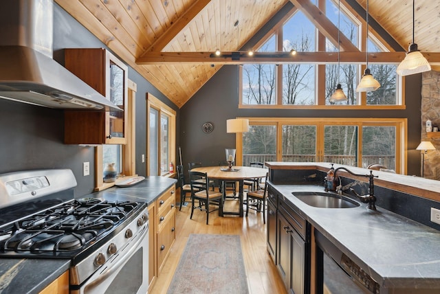 kitchen featuring light wood finished floors, wood ceiling, a sink, ventilation hood, and stainless steel gas range oven