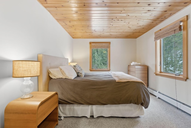 bedroom with wood ceiling, baseboard heating, and carpet flooring